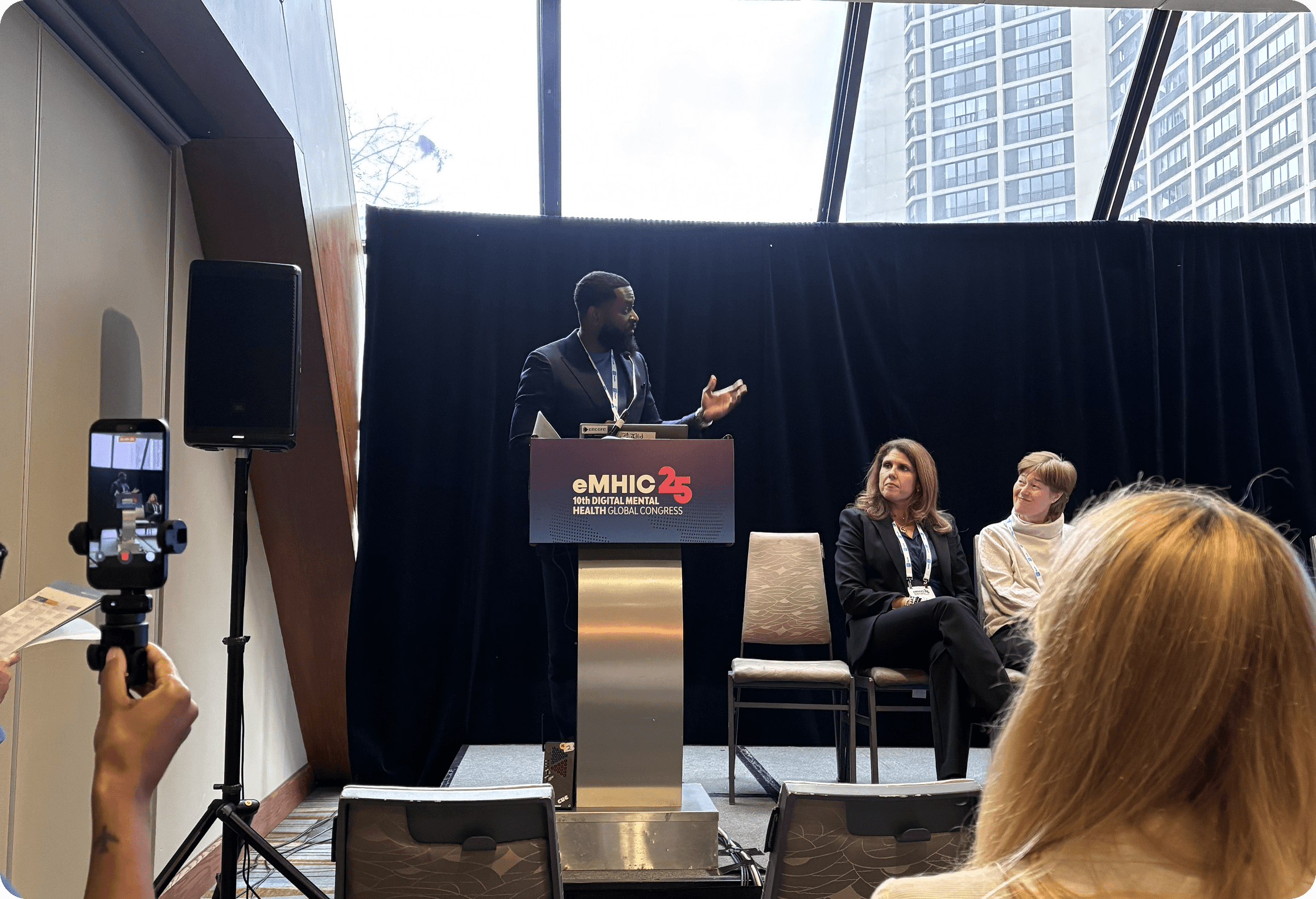 Swiftacare team member speaking on stage at the eMHIC digital mental health conference